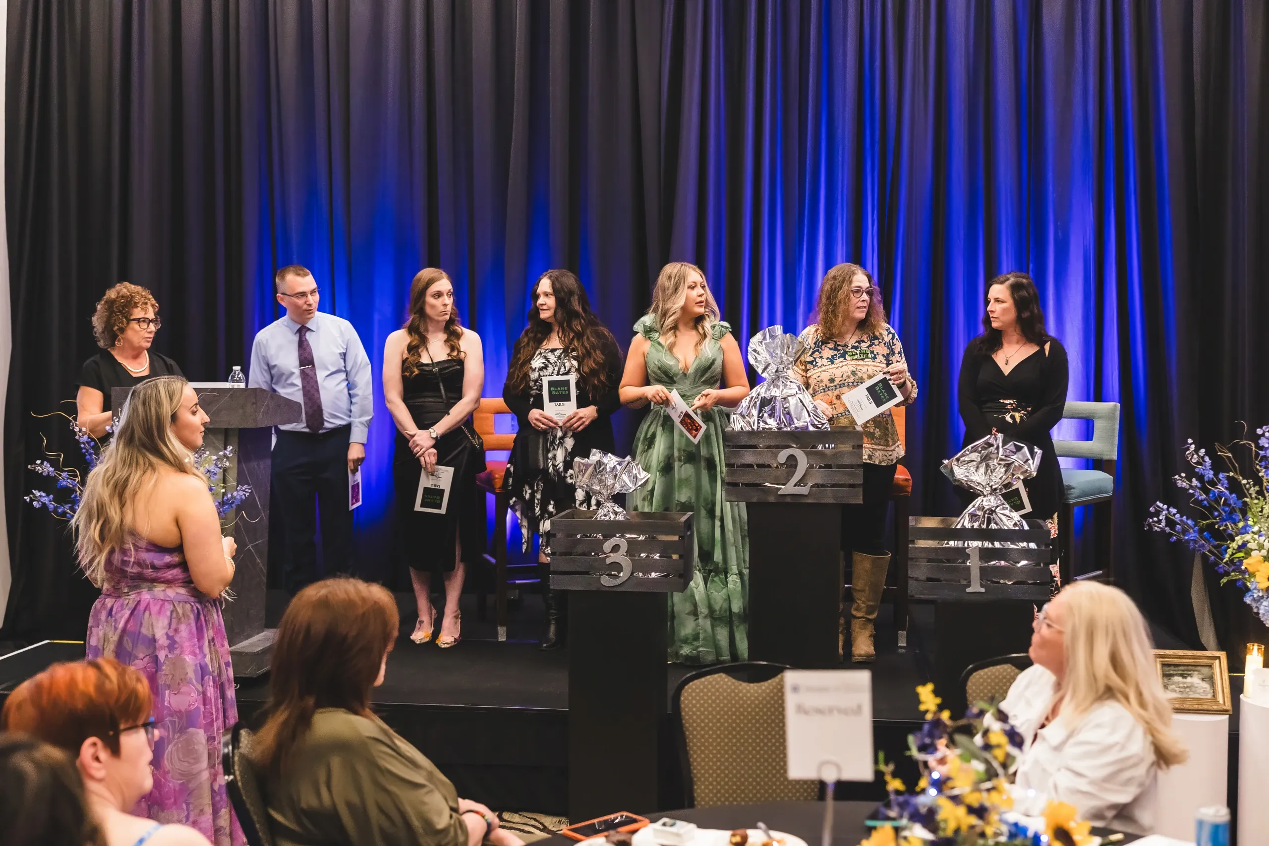 A row of people recognized on stage during the gala program.